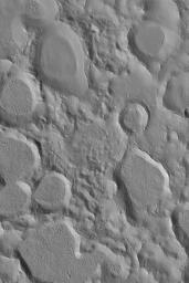 NASA's Mars Global Surveyor shows a portion of a large field of small craters clustered together in northeastern Arabia Terra on Mars. Crater clusters usually result from the secondary impact of debris thrown from a much larger impact.