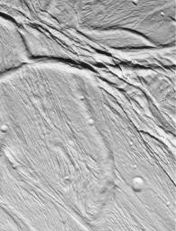 NASA's Cassini spacecraft took this image of the ropy, taffy-like topography on Saturn's moon Enceladus as it soared above the icy moon on Feb. 17, 2005.