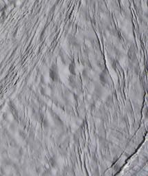 The finest details on the surface of Saturn's moon Enceladus are revealed in this 30-meter per-pixel, enhanced-color image taken during NASA's Cassini spacecraft closest-ever encounter with Enceladus on March 9, 2005.