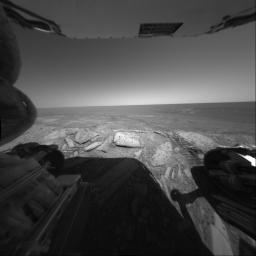 NASA's Mars Exploration Rover Opportunity looks back out at the plains of Meridiani Planum from the rover's first dip inside the rim of 'Endurance Crater.' Opportunity's rear hazard-avoidance camera took this picture on June 8, 2004.