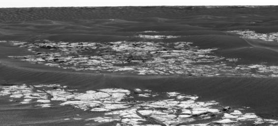 This is a mosaic of Erebus Crater, assembled from some of the images taken by the panoramic camera on NASA's Mars Exploration Rover Opportunity during the rover's 590th sol (Sept. 21, 2005).