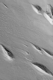 NASA's Mars Global Surveyor shows landforms found in the Medusae Sulci region of Mars. The most classic yardang shape is that of the inverted boat hull.