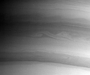 NASA's Cassini spacecraft captured this artistic view of elegant waves and ribbons of clouds near Saturn's south pole on Aug. 10, 2004.
