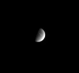 Saturn's Dione shows NASA's Cassini spacecraft some of the bright wispy streaks that cover much of the moon's trailing hemisphere in this image captured by NASA's Cassini spacecraft on Sept. 28, 2004.