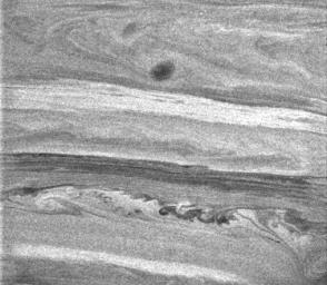 This image from NASA's Cassini spacecraft shows intricate undulations and swirls within the banded atmosphere of Saturn, which give scientists clues to the processes occurring there.