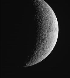 This view of Saturn's moon Tethys from NASA's Cassini spacecraft shows the contrast between the more heavily cratered region near the top and the more lightly cratered plains toward the bottom part of the image and near the limb.