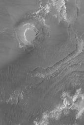NASA's Mars Global Surveyor shows a circular mesa and layered materials that are partially-exposed from beneath a thick, dark mantle in the Aureum Chaos region of Mars.