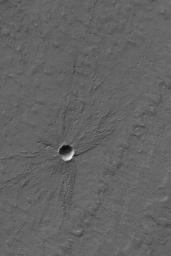 NASA's Mars Global Surveyor shows a small meteor impact crater in Mars' south polar layered terrain. A layer of material, several meters thick, has been stripped away since the time the crater formed.