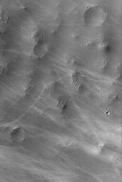 NASA's Mars Global Surveyor shows wild patterns of dark streaks thought to have formed by the passage of many dust devils. The dust devils disrupt the dust coating the martian surface, leaving behind a streak.