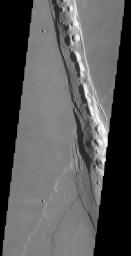 This image released on Nov 19, 2004 from NASA's 2001 Mars Odyssey shows collapse pits are found in graben located in Tractus Catena on Mars. These features are related to subsidence after magma chamber evacuation of Alba Patera.