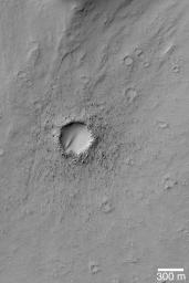 NASA's Mars Global Surveyor shows a relatively young impact crater on the floor of the outflow channel system of Mangala Valles on Mars. The impact ejecta blanket in this case is quite bouldery. Some windblown sediment has partially filled the crater.