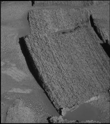 This image from NASA's Mars Exploration Rover Opportunity taken Dec. 3, 2004, shows light rocks and dark rocks along the rim of 'Endurance Crater' on Mars. The pictured rock, 'Tipuna,' lies just under the dividing line, in the dark section.
