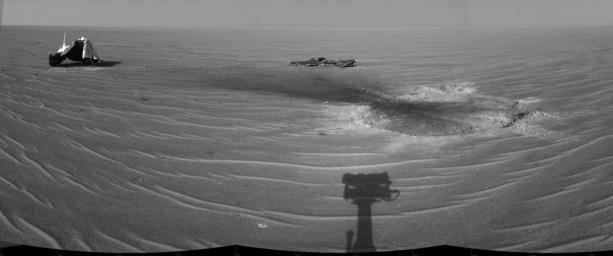 NASA's Mars Exploration Rover Opportunity gained this view of its own heat shield on Dec. 22, 2004. The main structure from the shield is to the far left. Additional fragments of the heat shield are seen. The heat shield's impact mark is visible.