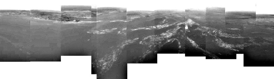 This composite was produced from images returned, January 14, 2005, by the ESA's Huygens probe during its successful descent to land on Titan. As the probe descended, it drifted over a plateau heading towards its landing site in a dark area.