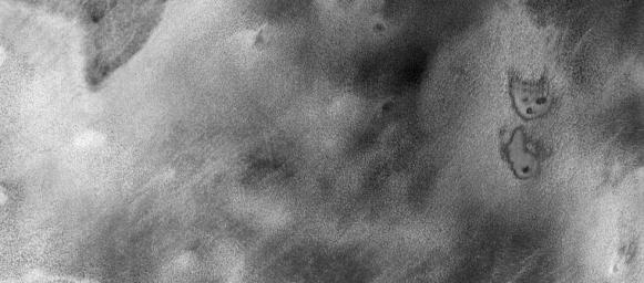 This image is part of THEMIS art month, taken by NASA's Mars Odyssey featuring a portion of Mars' landscape bearing a striking resemblance to a cartoon kitty.