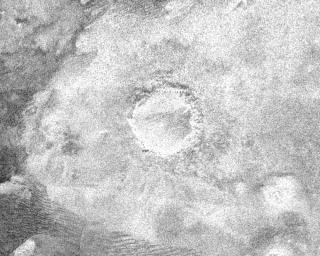 This image from NASA's Cassini spacecraft shows a crater, approximately 60 kilometers (37 miles) in diameter, on the very eastern end of the radar image strip taken by the Cassini orbiter on its third close flyby of Titan.