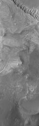 NASA's Mars Global Surveyor shows layered sedimentary rocks in southwestern Melas Chasma on Mars.