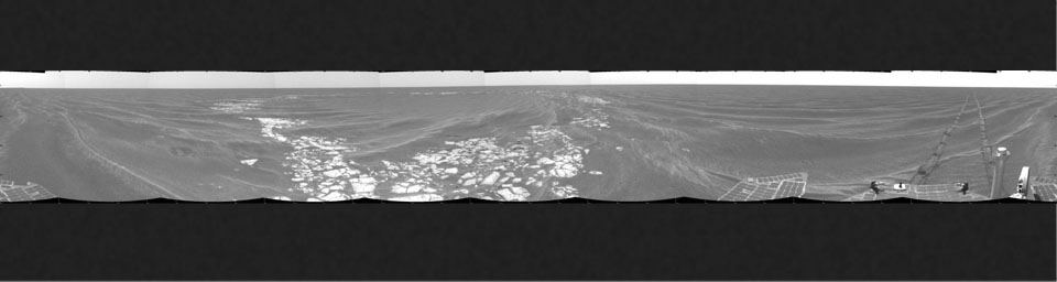 NASA's Mars Exploration Rover Opportunity took this cylindrical projection 360-degree view of the rover's surroundings on March 8, 2005 at Vostok Crater. Much of the crater is buried in sand.