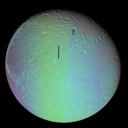 The cratered and cracked disk of Saturn's moon Dione looms ahead in this mosaic of images taken by NASA's Cassini spacecraft on Oct. 11, 2005, as it neared its close encounter with the icy moon.
