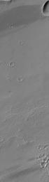 NASA's Mars Global Surveyor shows impact craters and wind streaks in Daedalia Planum on Mars.