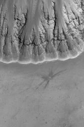 This image from NASA's Mars Global Surveyor shows a relatively fresh crater with dark, rayed ejecta on an upland plain above one of the many depressions in the eastern Labyrinthus Noctis region.