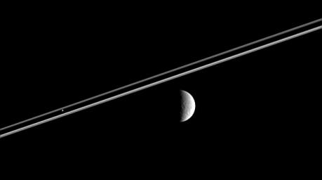 Distant Rhea (right) poses here for NASA's Cassini spacecraft, as Pandora hovers against Saturn's dark shadow on the rings.