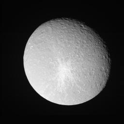 Rhea shows off her bright, fresh-looking impact crater in this view from NASA's Cassini view taken during a close approach.