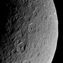 NASA's Cassini spacecraft looks down upon Rhea, whose cratered surface was already ancient before any complex life developed on Earth. The terrain seen here has probably changed little in the past billion years.