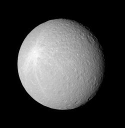 Rhea's crater-saturated surface shows a large bright blotch, which was likely created when a geologically recent impact sprayed bright, fresh ice ejecta over the moon's surface. This is image is from NASA's Cassini spacecraft.
