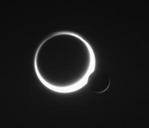 Saturn's two largest moons meet in the sky in a rare embrace. Smog-enshrouded Titan glows to the left of airless Rhea. This image was taken in visible light with NASA's Cassini spacecraft's narrow-angle camera on June 11, 2006.