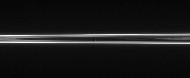 The narrow and twisted F ring lights up this scene, which features Mimas against the unlit side of Saturn's ringplane. This image was taken in visible light with NASA's Cassini spacecraft's narrow-angle camera on June 13, 2006.