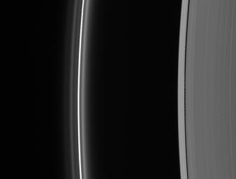 Edge waves in the Keeler Gap betray the presence of the embedded moon Daphnis. At left lies the brilliant F ring with its flanking strands as seen by NASA's Cassini spacecraft.