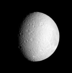 Bright streaks adorn the face of densely cratered Rhea, Saturn's second largest moon as seen by NASA's Cassini spacecraft.