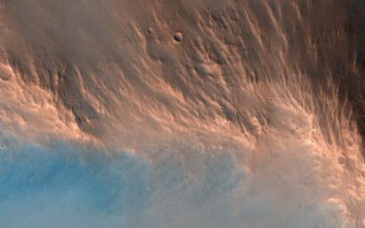 This image from NASA's Mars Reconnaissance Orbiter reveals an impact crater, nine kilometers in diameter, with a central peak. Impact craters of various sizes and ages can be found across the Martian surface.