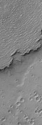 NASA's Mars Global Surveyor shows the sinuous margin of a dust-covered, ridged lava flow in southern Daedalia Planum, Mars.