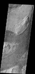 The dark platy lava flow in this image is confined to a channel on Mars as seen by NASA's Mars Odyssey spacecraft.