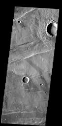 The ejecta surrounding this crater in Tempe Terra has an unusual texture that appears to contain small channels and fractures on Mars as seen by NASA's Mars Odyssey spacecraft.