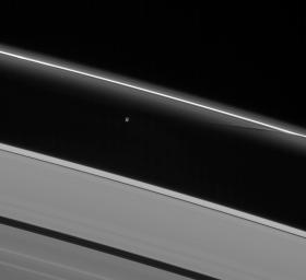 Prometheus interacts gravitationally with the inner flanking ringlets of the F ring, creating dark channels as it passes. This image is from NASA's Cassini spacecraft.