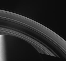 NASA's Cassini spacecraft looks across Saturn's cloud-dotted north and shadowed pole, and out across the lanes of ice that compose its rings.