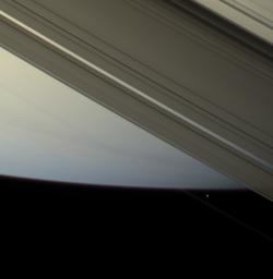 The F ring shepherd moon Prometheus touches the face of Saturn once more before moving off into blackness and continuing in its orbit. Images were obtained by NASA's Cassini spacecraft's narrow-angle camera on April 13, 2007.