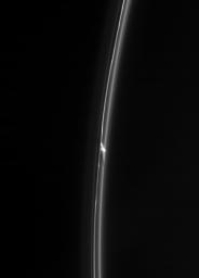NASA's Cassini spacecraft spies an intriguing bright clump in Saturn's F ring. Also of interest is the dark gash that appears to cut through the ring immediately below the clump.
