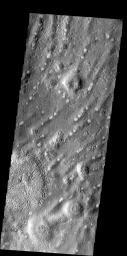 This ridged and pockmarked surface is located west of Phlegra Montes in the northern plains on Mars as seen by NASA's Mars Odyssey spacecraft.
