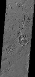This image shows a small portion of the Martian dichotomy near Lucus Planum. The ancient crater at the right center of the images has been extensively modified by the fracturing on Mars as seen by NASA's Mars Odyssey spacecraft.