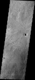 These lava flows surrounding a depression in the plains are located in the Cerberus region of Elysium Planitia on Mars as seen by NASA's 2001 Mars Odyssey spacecraft.