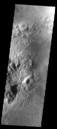 This unnamed northern crater on Mars contains several dune fields as seen by NASA's Mars Odyssey. Within the central peak region (left side of image) there is material with a 'swirled' surface pattern/texture.