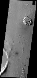 This ejecta blanket surrounding this small unnamed crater on the margin of Eumenides Dorsum has steep margins created by erosion on Mars as seen by NASA's Mars Odyssey spacecraft.