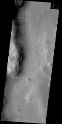 The side of this hill in Phlegra Montes appears darker than its surroundings. Covering material may have slumped off the steep slope due to gravity on Mars as seen by NASA's Mars Odyssey spacecraft.