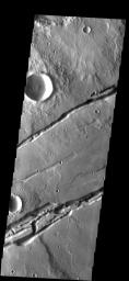 This image from NASA's Mars Odyssey spacecraft shows two sets of fractures on Mars, part of Sirenum Fossae. Several graben (downdroped blocks bounded by faults) occur between the main fracture systems.