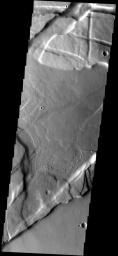 This image from NASA's Mars Odyssey spacecraft shows the maze-like western part of Valles Marineris called Noctis Labyrinthus. Younger lava flows from the Tharsis volcanos have filled the low areas.