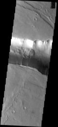 This image from NASA's Mars Odyssey spacecraft shows a landslide occurred within Coprates Catena. The Catena parallels Vallis Marineris.